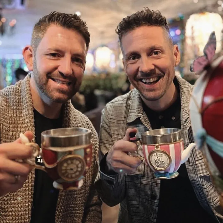 Two guests toasting with teapot cocktails at Enchant